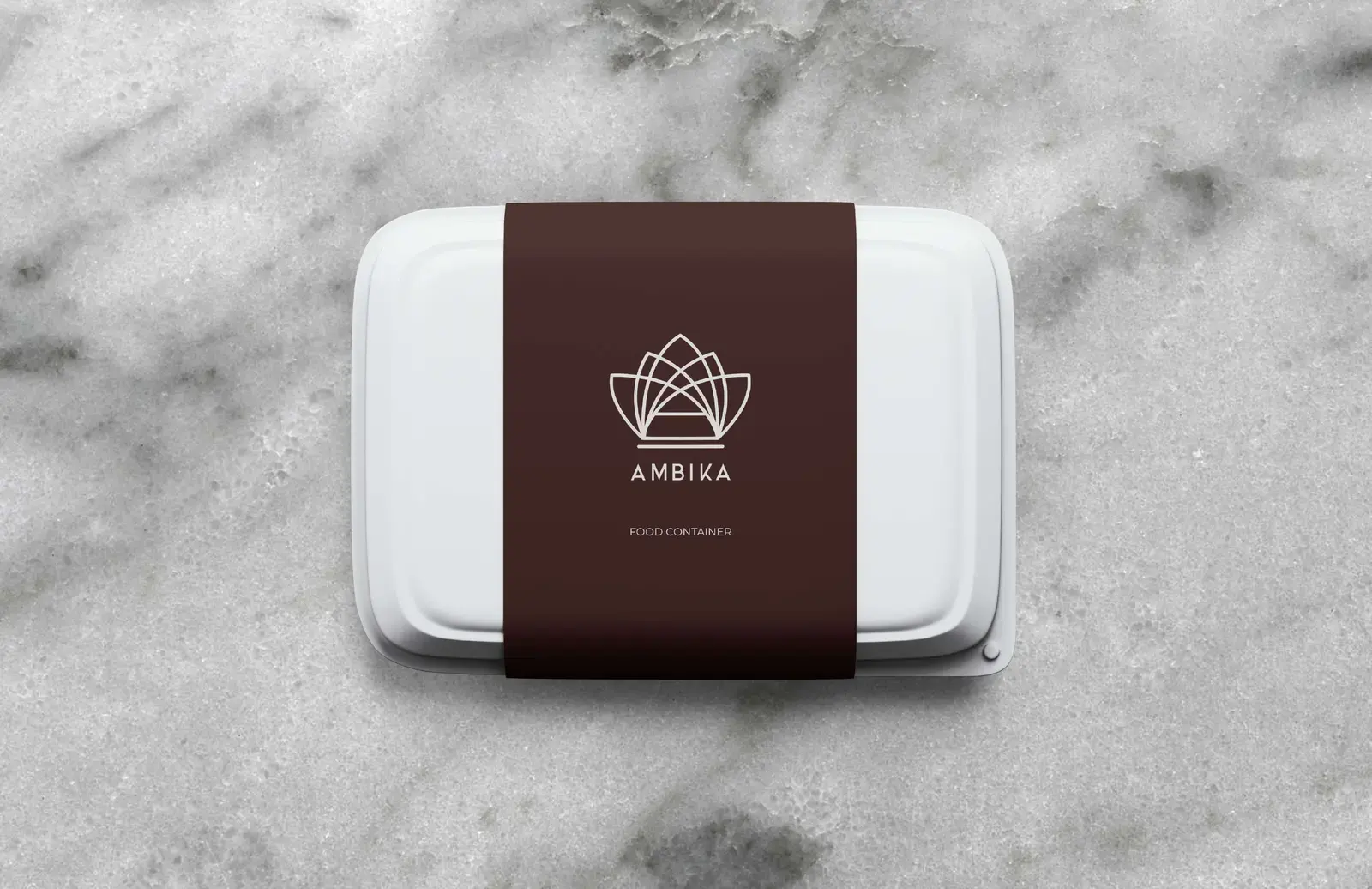Ambika takeaway container wrapped with a deep oxblood brand sleeve