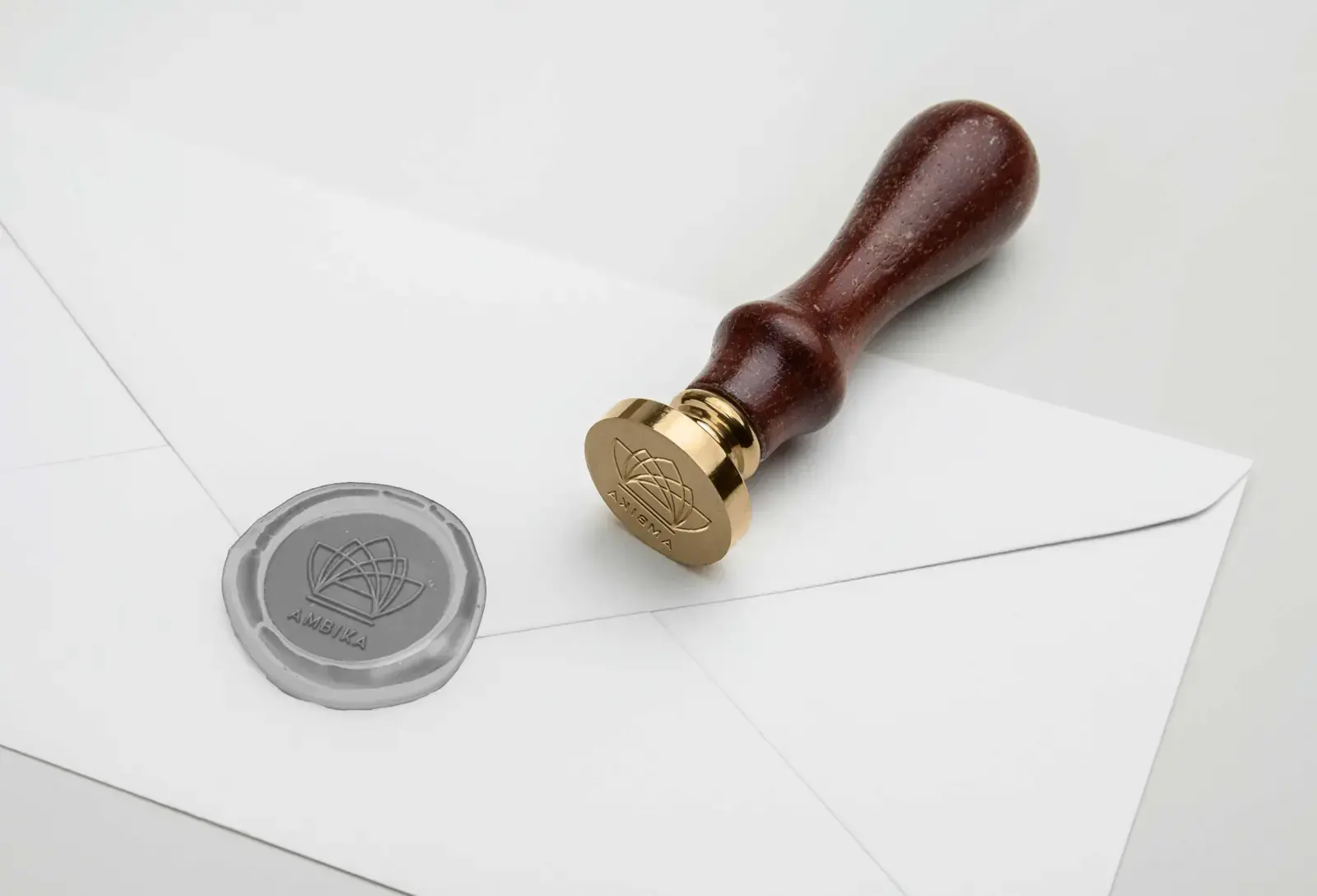 Ambika geometric emblem pressed into a grey wax seal