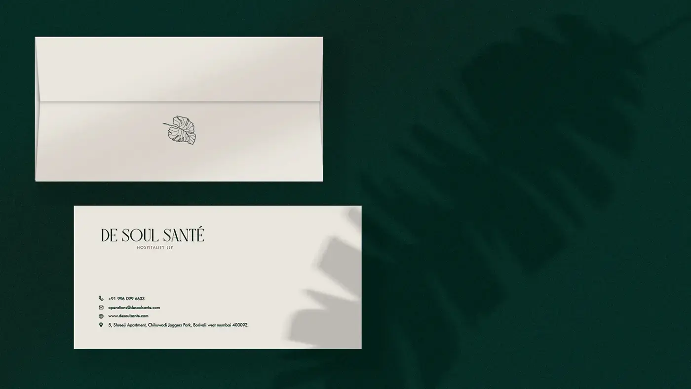 De Soul Santé envelope and business card on a deep green background