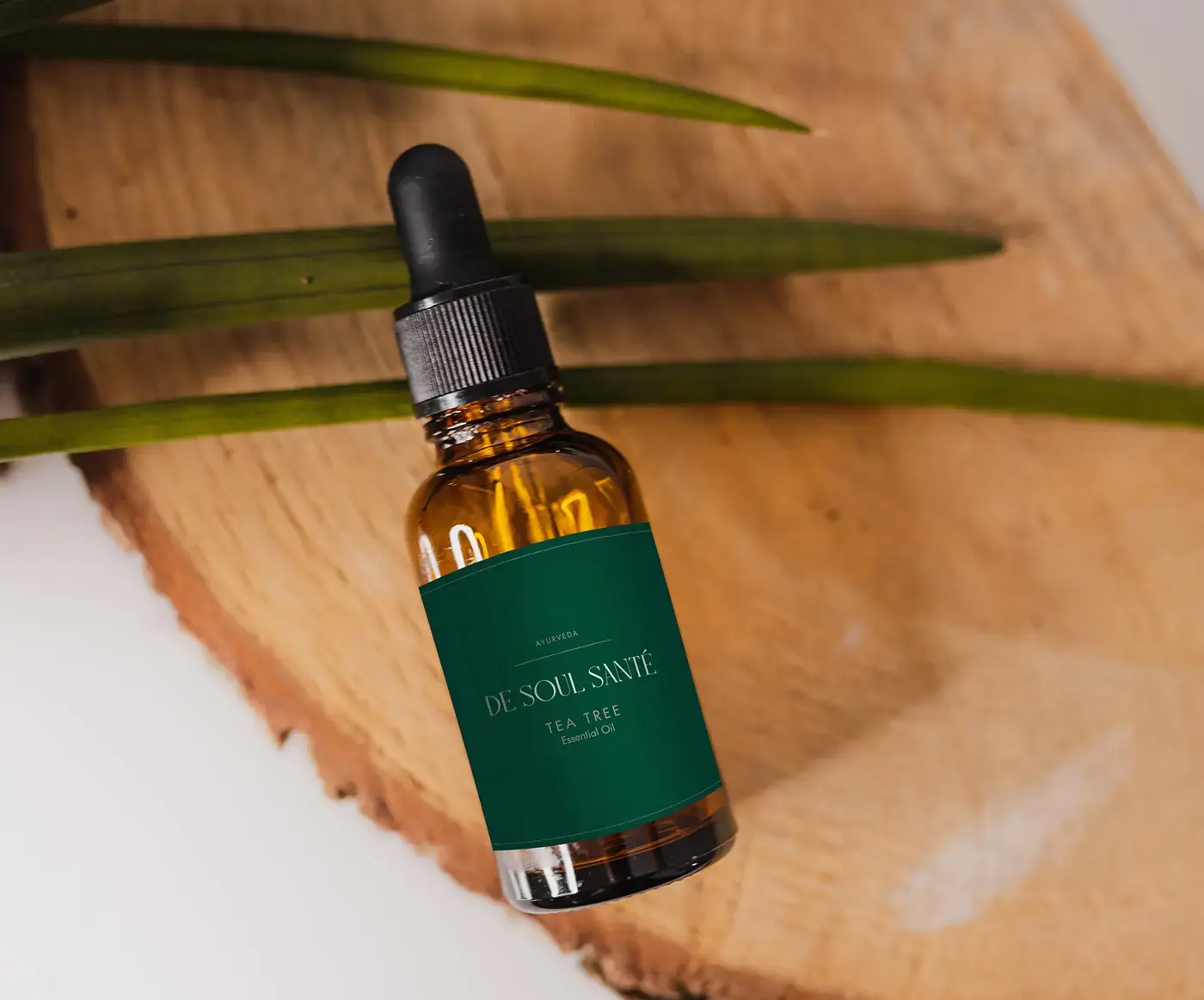 Amber treatment-oil bottle with a deep green De Soul Santé label