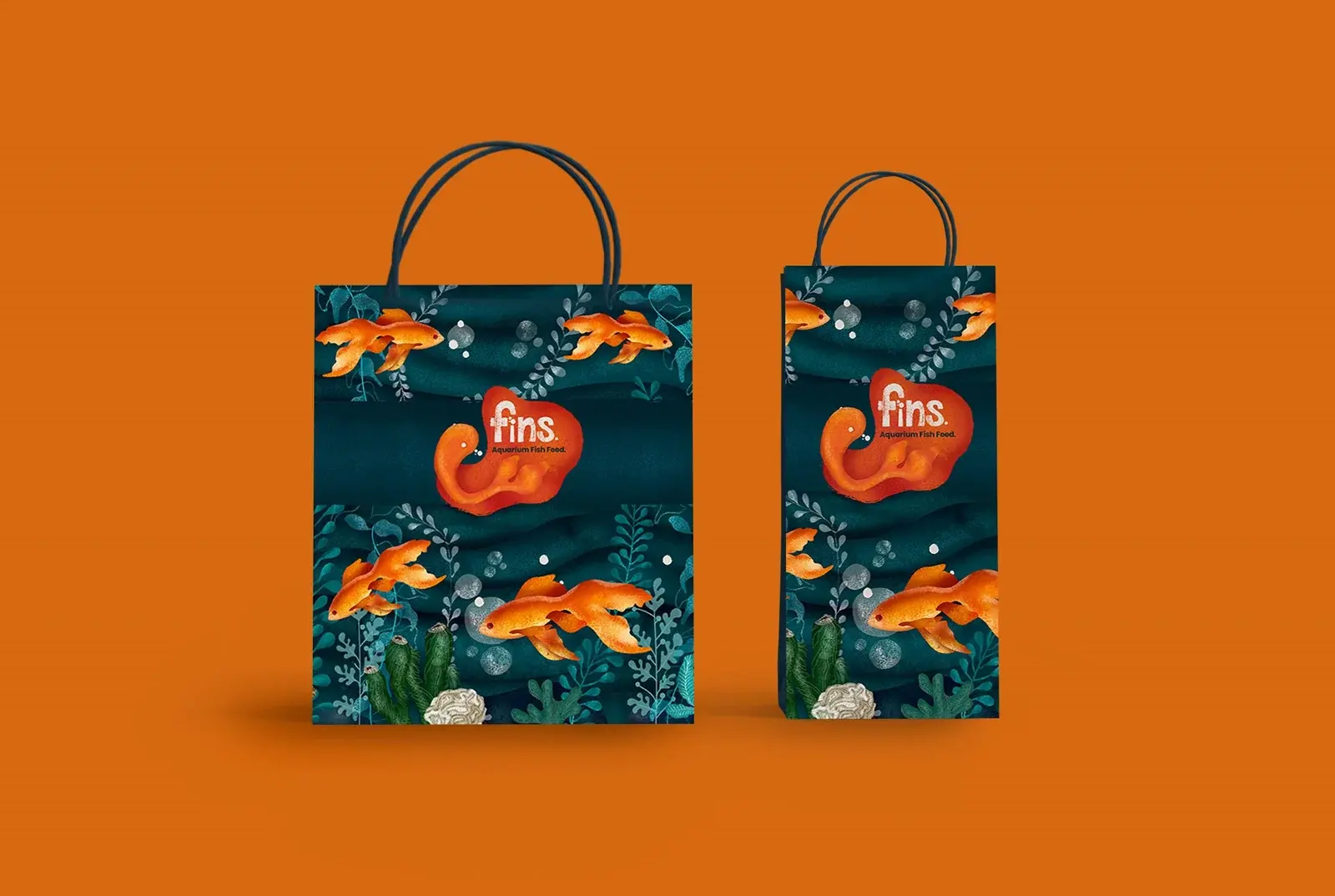 Two Fins retail bags displaying underwater packaging artwork on orange