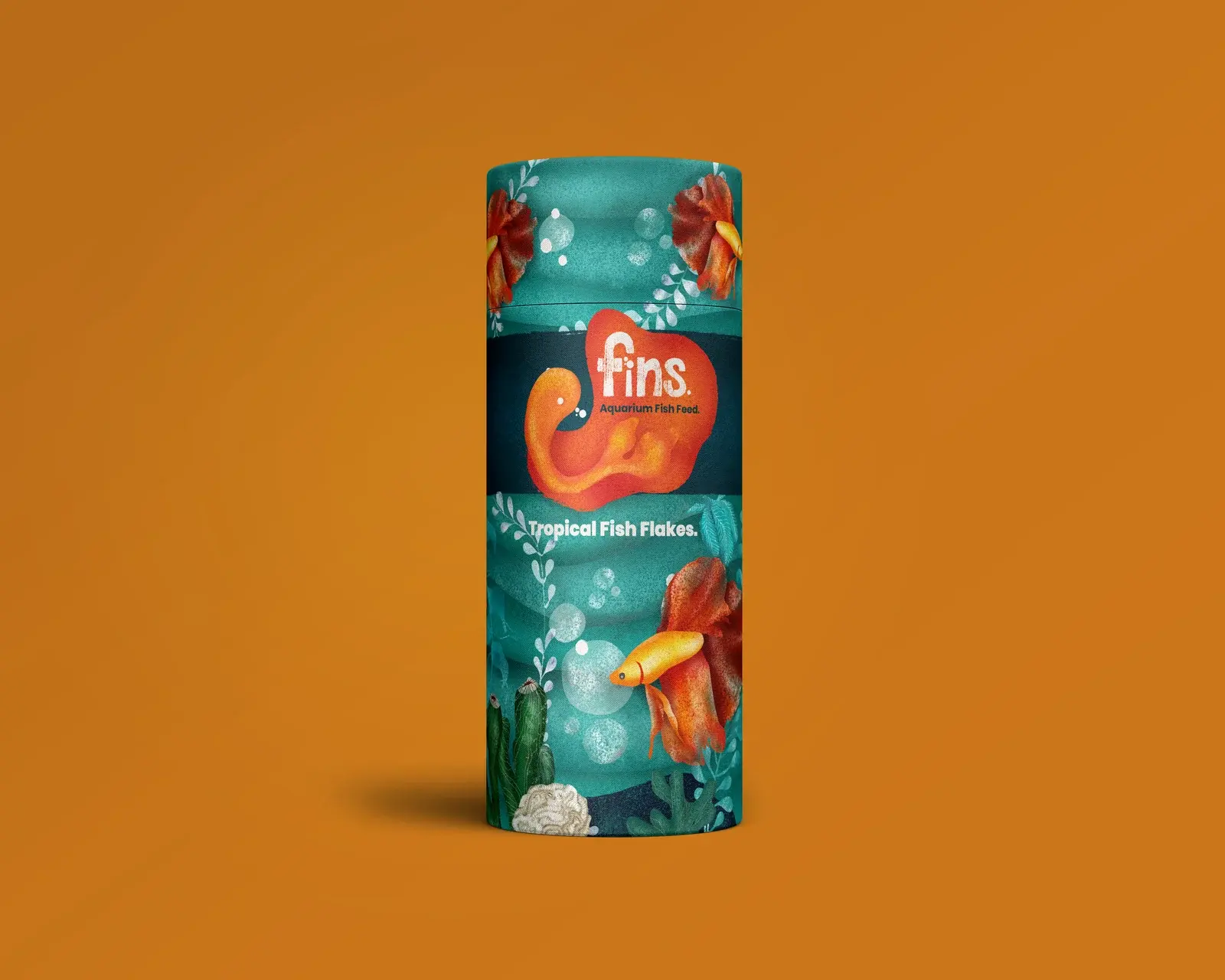 Fins Tropical Fish Flakes paperboard tube on a warm ochre background