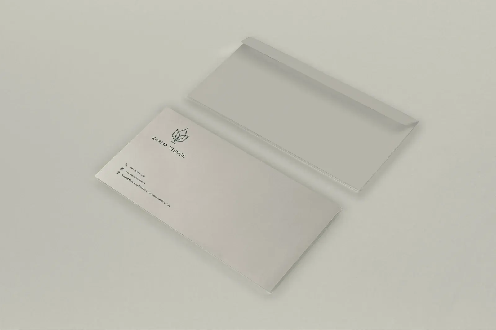 Minimal Karma Things envelope and letter on a warm ivory surface