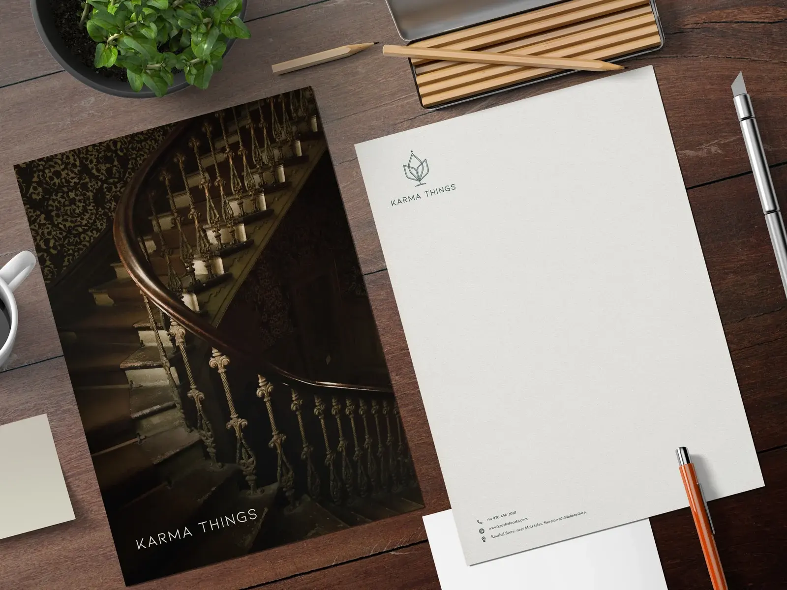 Karma Things letterhead and dark-green folder arranged on an antique writing desk